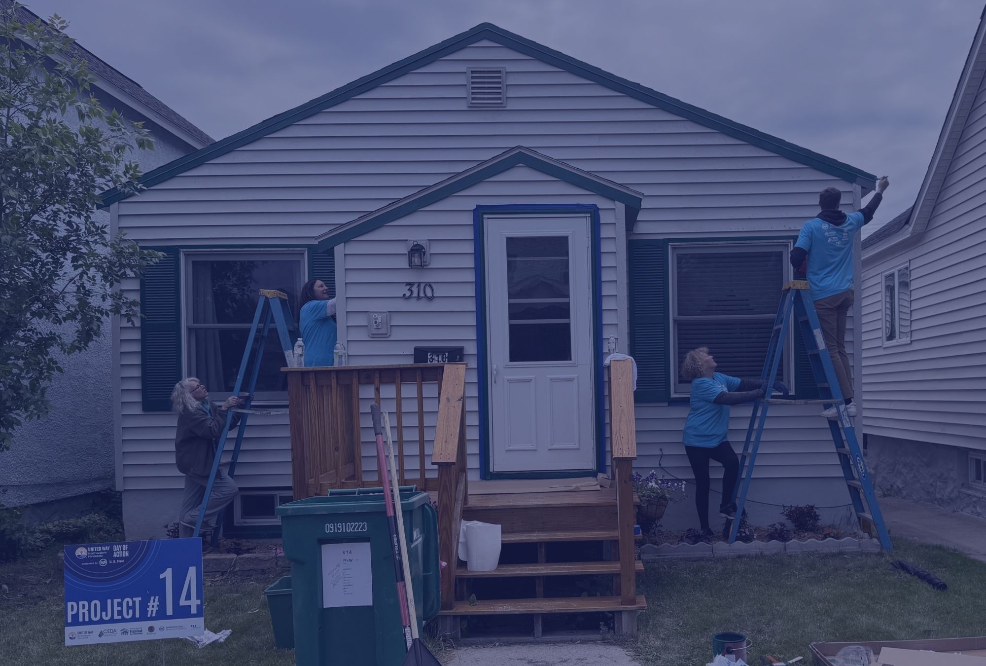 volunteers paint a house for Day of Action 