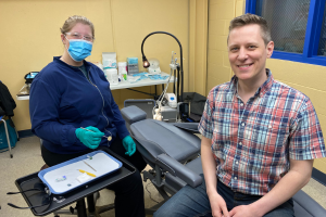 Man sitting with dental hygenist