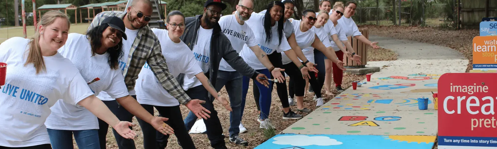 Volunteers point toward finished Born Learning trail 