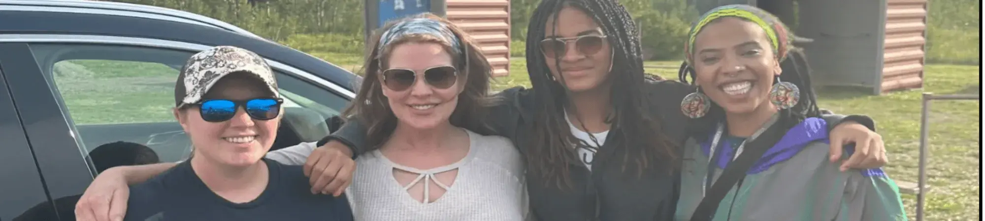Check and Connect mentors and mentees smile spending time at Redhead MTB Park