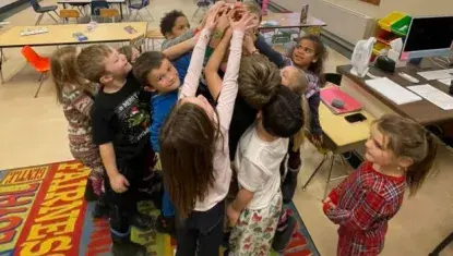 Children high five at UWNEMN Partner Agency Boys & Girls Club of Hibbing