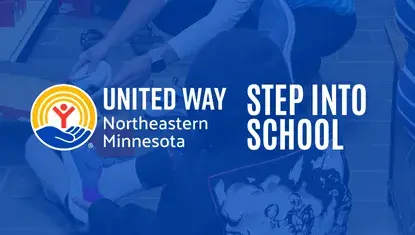 Volunteer helps a student try on shoes for 2024 Step Into School program