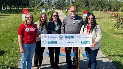 United Way of NE MN and LakeWood Regional Healthcare Foundation prepare for a ribbon cutting at the new Born Learning Trail in Timber Mill Park