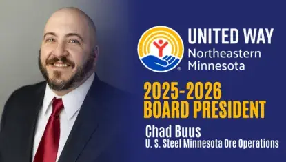 2025-2026 UWNEMN Board President Chad Buus smiles wearing a suit and tie.