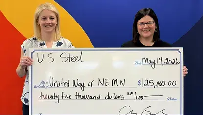 U. S. Steel Minnesota Ore Operations' Chrissy Bartovich, left, presents a check for $25,000 to United Way of Northeastern Minnesota's Erin Shay